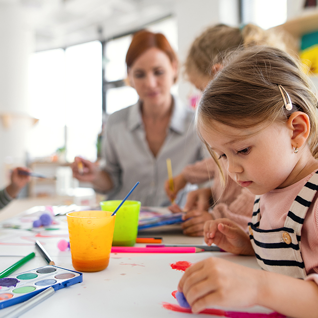 Little girl in class painting